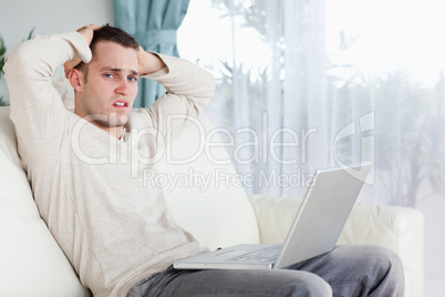 Sad man working with his laptop