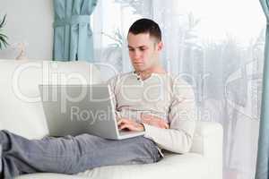 Young man working with his laptop