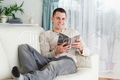Smiling man holding a book