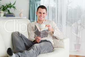 Happy man reading a book