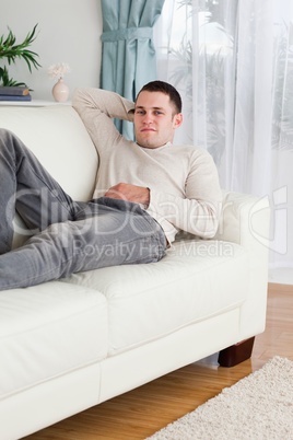 Portrait of a man lying on a sofa