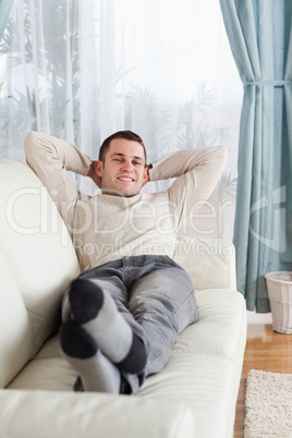 Portrait of man lying on a sofa