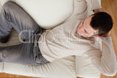 Young man lying on a sofa