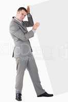 Portrait of young businessman pushing a blank panel