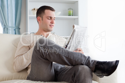 Handsome man reading the news while having a coffee