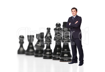 Businessman in front of black chess pieces