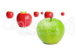 Green apple in front of red apples