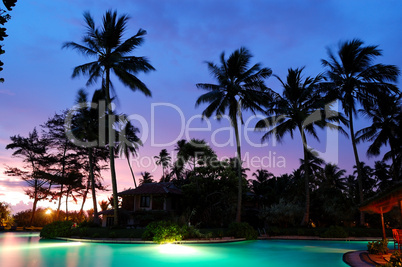 Sunset and illuminated swimming pool, Bentota, Sri Lanka