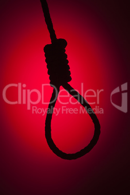 Silhouetted Hangman's Noose Over Red Background