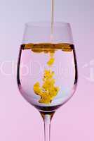 Olive oil being poured into wine glass