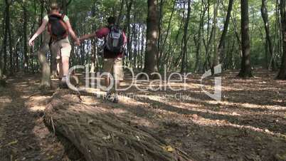 Young people trekking in woods