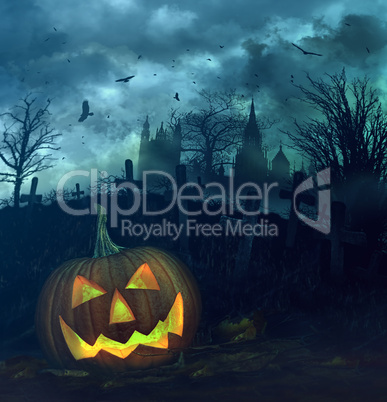 Halloween pumpkin in spooky graveyard