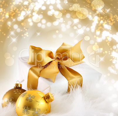 Gold ribboned gift with holiday background