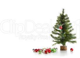 Small artifical tree with ornaments on white