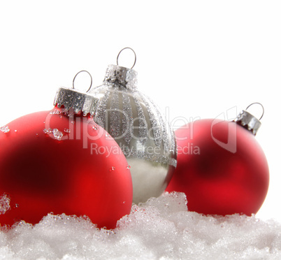 Three red christmas balls in the snow