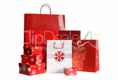 Various sizes of holiday shopping bags and gift boxes on white