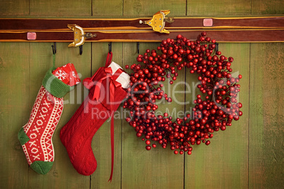Christmas stockings and wreath hanging on  wall