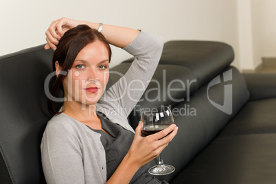 Elegant businesswoman sit leather sofa drink wine