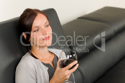 Elegant businesswoman sit leather sofa drink wine
