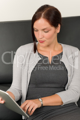 Businesswoman touch tablet computer leather sofa