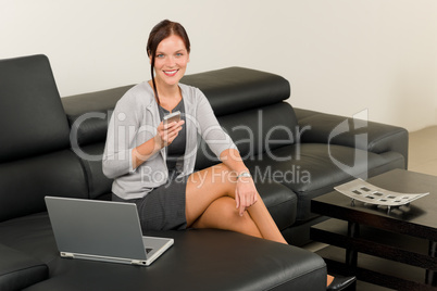 Elegant businesswoman on leather sofa call phone