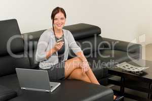 Elegant businesswoman on leather sofa call phone