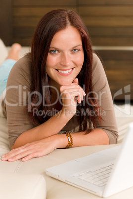 Modern living room woman lying sofa laptop