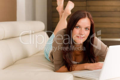 Modern living room woman lying sofa laptop