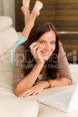 Modern living room woman lying sofa laptop