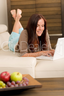 Modern living room woman lying sofa laptop