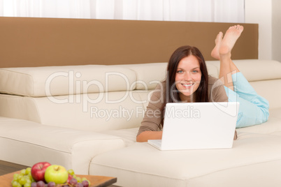 Modern living room woman lying sofa laptop