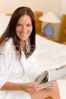 Attractive woman read morning newspapers bedroom
