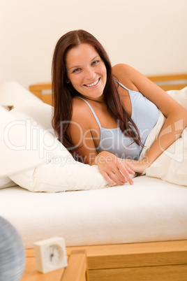 Bedroom smiling woman portrait in white bed