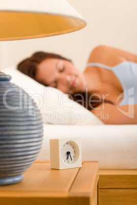 Alarm clock Woman sleeping in white bed