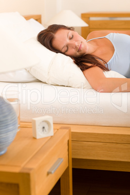 Alarm clock Woman sleeping in white bed