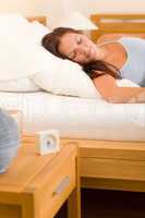 Alarm clock Woman sleeping in white bed