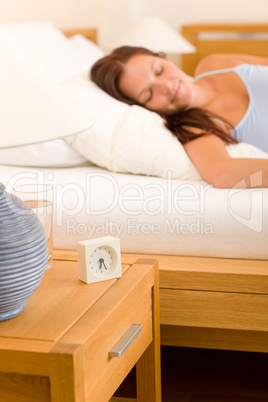 Alarm clock Woman sleeping in white bed