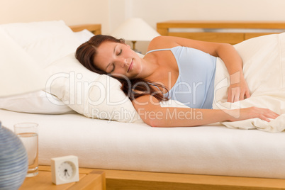 Alarm clock Woman sleeping in white bed