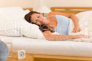 Alarm clock Woman sleeping in white bed
