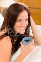 Bedroom - young woman drink coffee in bed