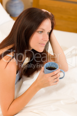 Bedroom - young woman drink coffee in bed