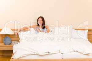 Bedroom - young woman drink coffee in bed
