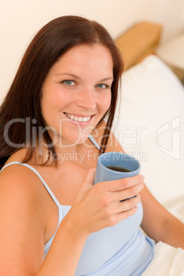 Bedroom - young woman drink coffee in bed