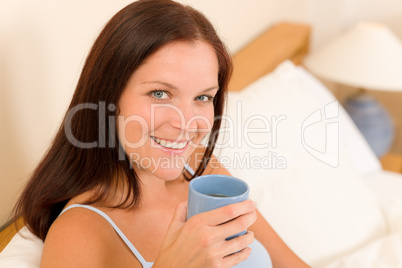 Bedroom - young woman drink coffee in bed