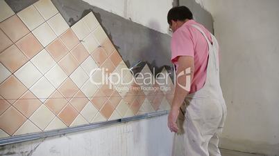Installing Tiles - Applying mortar to wall