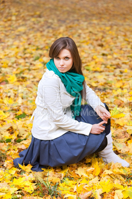 Beautiful woman in white coat and scarf