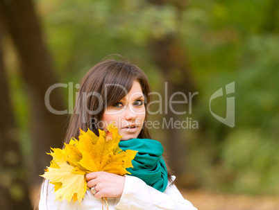 Beautiful woman portrait with yellow leaf