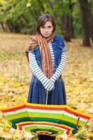Young pretty girl with striped umbrella