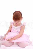 Full length portrait of a sad little ballerina dressed in pink