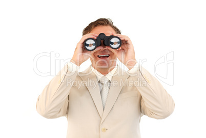 Smiling businessman looking through binoculars